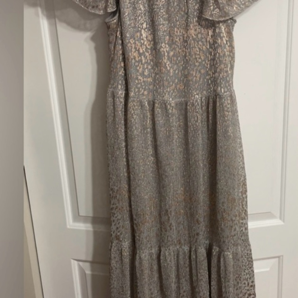 Elegant silver mesh like fabric with gold specks.